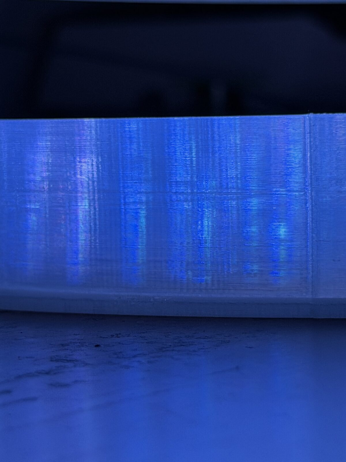 The clear wall lit from inside before sanding, each LED smeared into a vertical streak