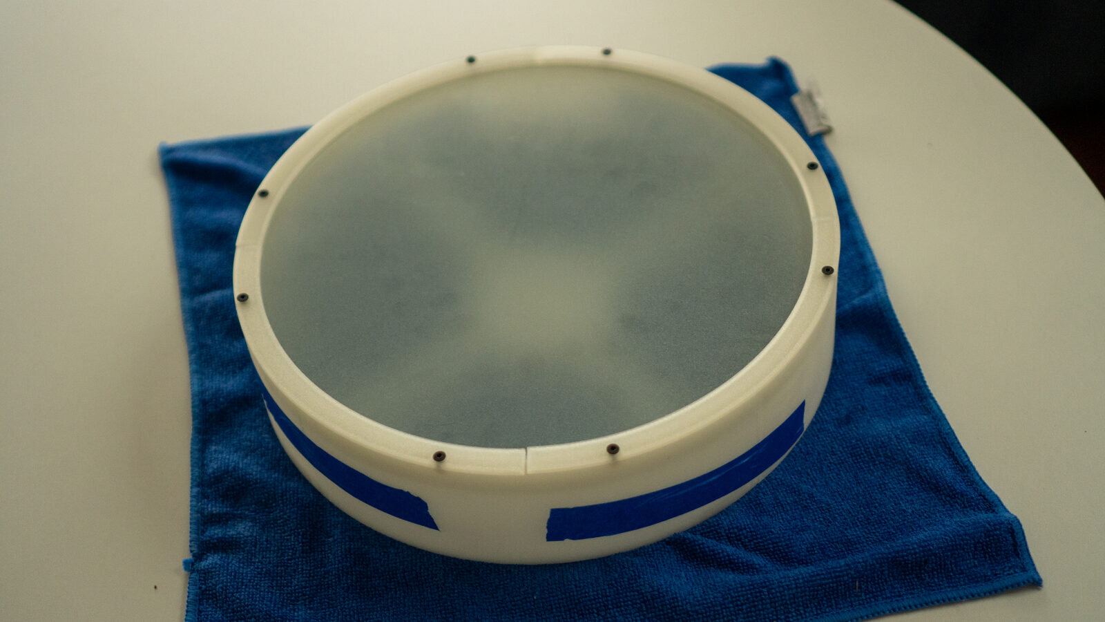 The glued round wall with the frosted glass and ring on top, tape over the seams
