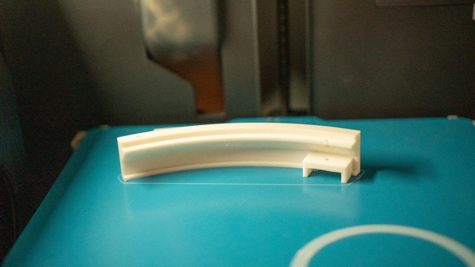A clear test print still on the printer bed