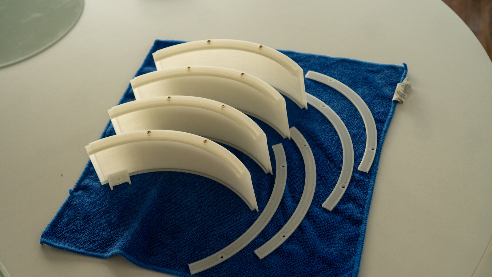 Four clear wall quarters and four ring quarters on a blue towel