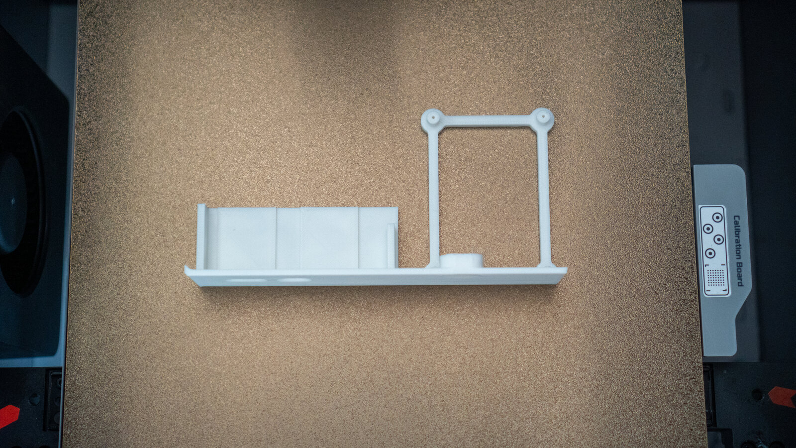 A small test print of the bottom wall with the ports