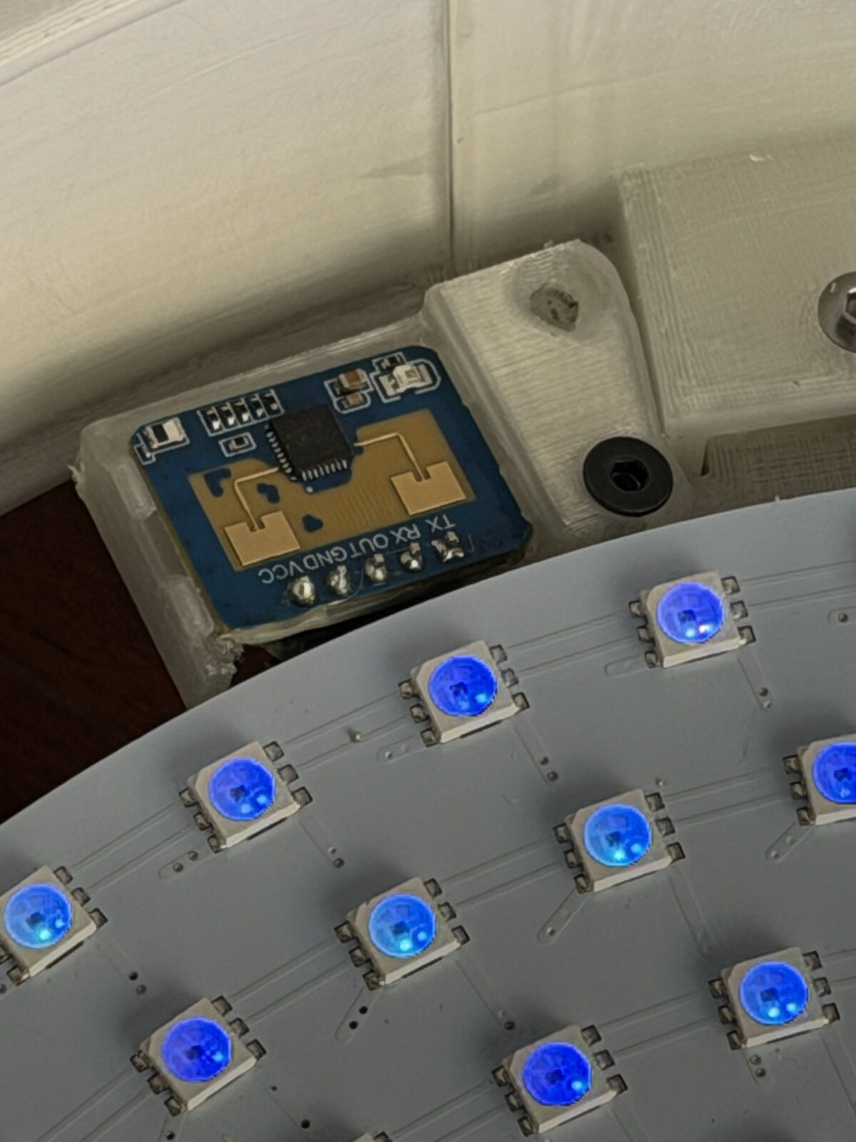 The radar board in its clear tray next to the edge of the disk