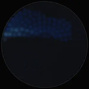 Dark water with a few waves crossing the disk, then long slow evenly spaced waves